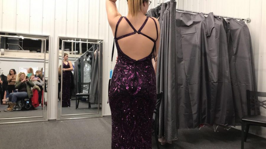 Emma Jarrett tries on a velvetish bedazzled dress with a unique open back. This dress can be found at TeraLees Formals in Osceola, Indiana.