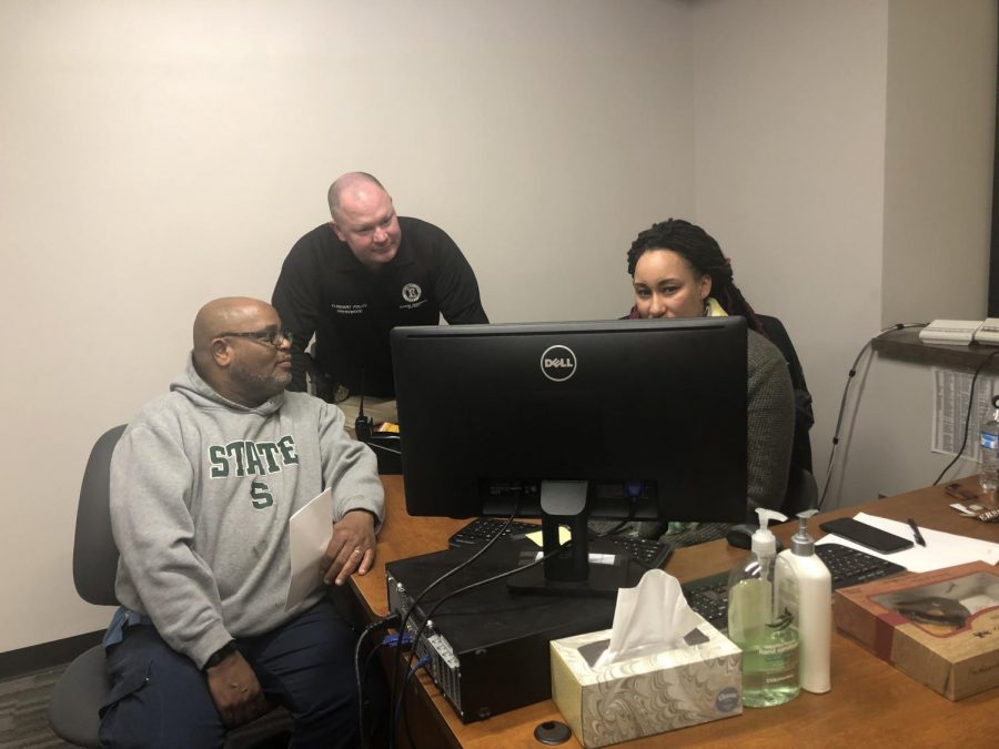 Head of maintenance, Willie Coleman, SRO Bobby Presswood, and security paraprofessional Leticia Armstrong review security footage on Wednesday, Feb. 13. SRO Presswood plans to bring a situational awareness program to Memorial in the spring.  