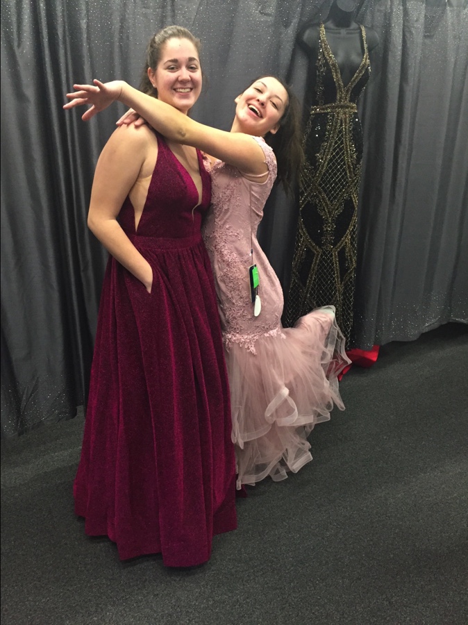 Mackenzie Umbaugh (left) wears a beautiful velvet dress that contrasts with the color of her skin, and Sadie Bastardo (right) wears a tight fitting pink dress with some tulle at the bottom. These dresses can be found at TeraLees Formals in Osceola, Indiana.