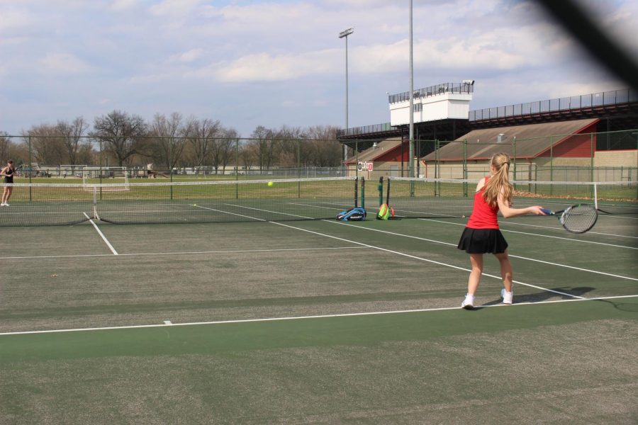 Sophomore Callan Kubiak plays singles with an opponent from Northwood High School during the varsity game on Tuesday, April 16.