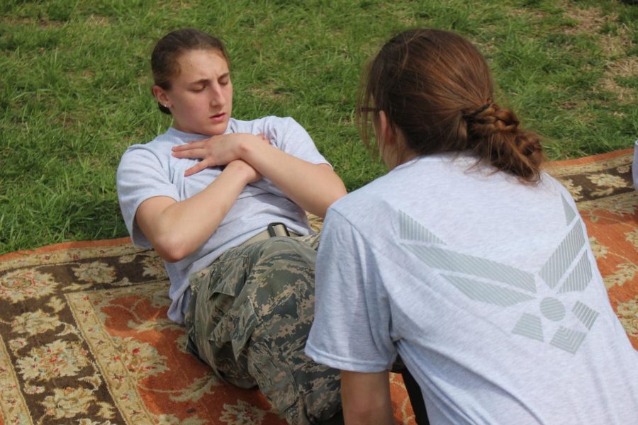 Kallie Canfield does sit-ups at the JROTC Raider Competition on Saturday, April 13 at Terre Haute. Canfield successfully reached her goal and got a perfect score for her 79 total sit-ups performance.