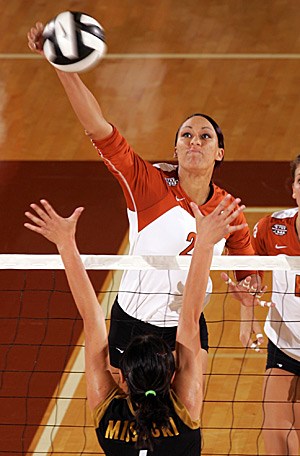 Miss Armstrong spikes the ball over a Missouri defender. Armstrong played for the Longhorns from 2003-2008. 