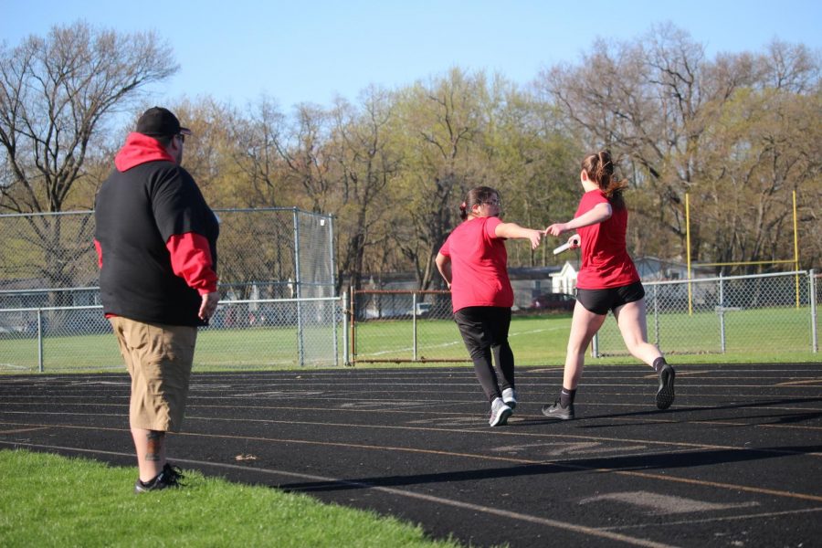 Sophomores Emily Kersten Tatiana Ponce Acevedo, are handing off the batton during the 4x100 on April 26th, 2019. 
