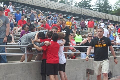 Elkhart Memorial Unified track alumni congratulate members of this years team after watching them compete.