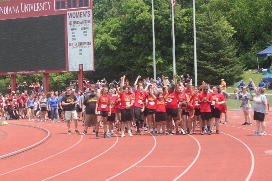 The Elkhart Memorial Unified Track team completes the Charger Cheer as they are being introduced before receiving their medals.