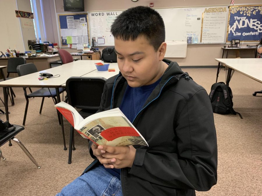 Junior Richard Bautista reads The Good Man of Nanking, the diary of John Rabe, during class on Friday, Aug. 23.