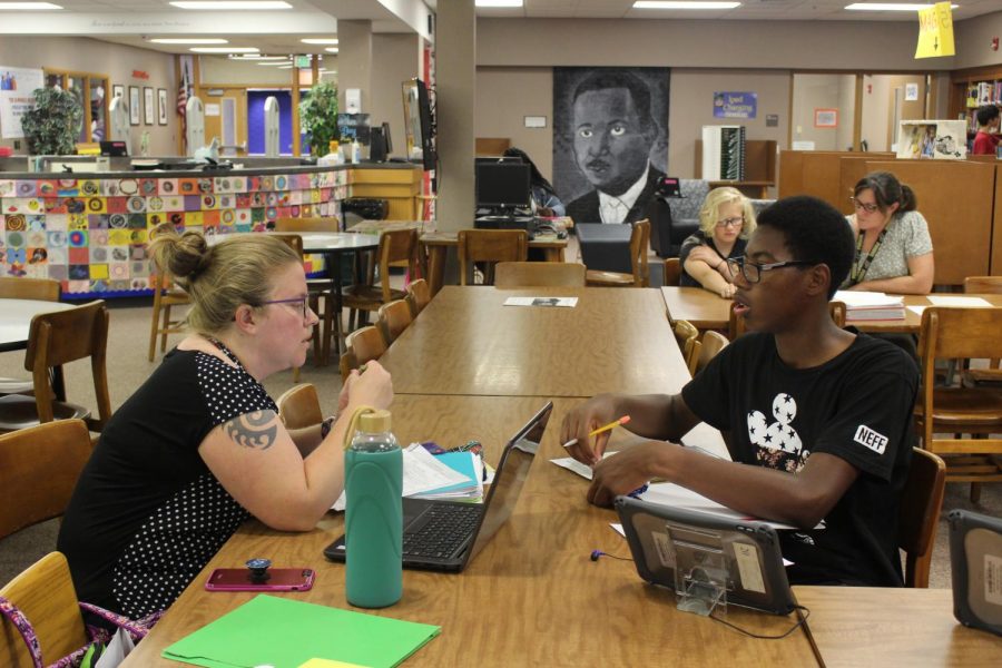 Biology teacher Cara McMenamin and freshman Henry Spivey work together in the library after school on Thursday, Sept. 12. Elkhart Memorial offers a unique tutoring program where teachers are available after school in the library on Tuesdays, Wednesdays, and Thursdays until 4:00 p.m.