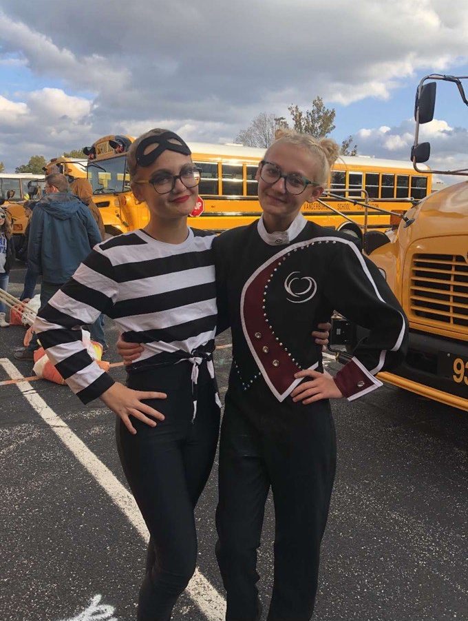 Freshman Elizabeth Siddons and sophomore Kaitlyn Siddons pose for a picture before performing at the Semistate marching band competition at Pike High School on Saturday, Nov. 2.
