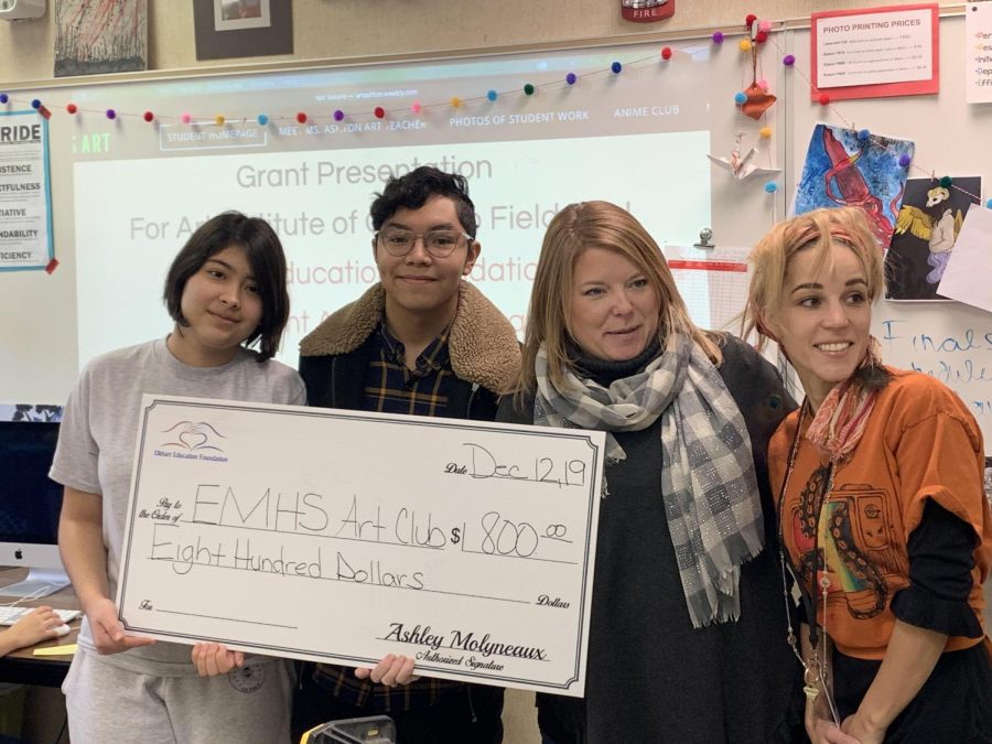 Sophomore Ariana Correa, senior Mario Castro, Ashley Molyneaux from the Elkhart Education Foundation, and Art teacher, Heather Ashton pose for a celebratory picture during the Art Club grant award presentation on Thurs. Dec. 12. The grant will allow Art Club students to take a trip to the Art Institute of Chicago. 