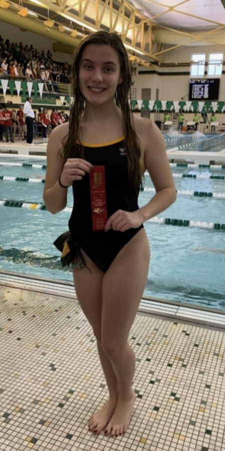Sophomore Rachel Terrell wins 2nd place in the 100m butterfly at the NLC girls swim meet on Saturday, Jan. 18. The girls will compete for their sectional titles in two weeks.