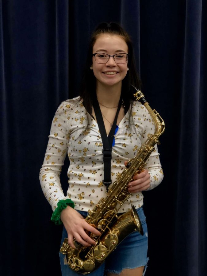 Musician of the week, junior Rebecca Ekema poses with her instrument in the band room.