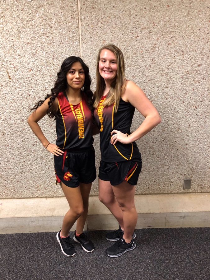 Juniors Jennifer Diaz and Kelsey Knowlton pose for picture during a track meet on March 16th 2019.