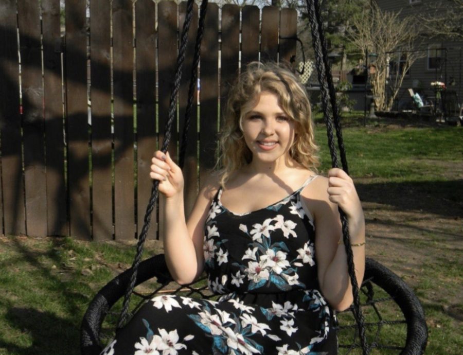 Maddy poses on a swing for a photo taken on April 19. Her hard of hearing started at birth, and since then she has had fourteen surgeries. She shared her inspiring story with GENESIS. 
