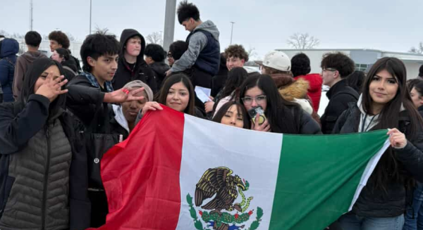 Students hold up a flag.