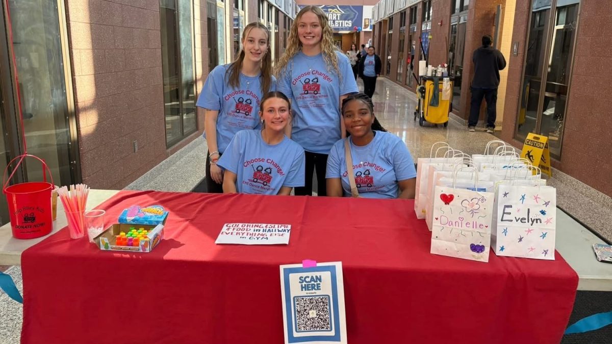 Riley Dance-a-thon committee poses at a table.