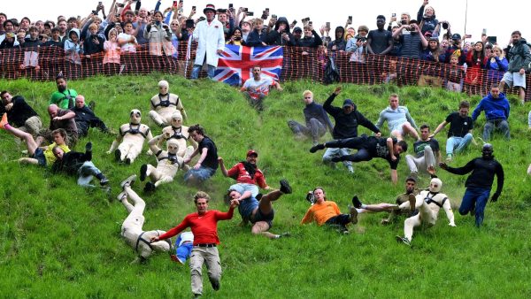 Many contestants in the cheese rolling contest slide and fall down a hill in England.