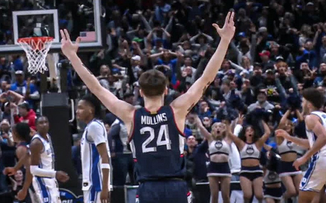 Mullins raises arms in excitement.